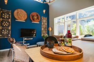 a table with a bottle of wine and some food at Frafjord Apartments Thor in Dirdal