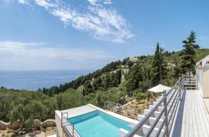 a swimming pool on the side of a house at Villa Alexa in Gaios