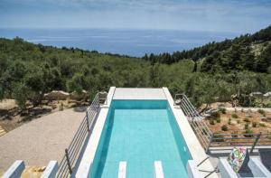 a swimming pool with a view of the ocean at Villa Alexa in Gaios
