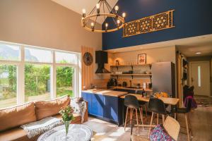 a kitchen and living room with a couch and a table at Frafjord Apartments Thor in Dirdal