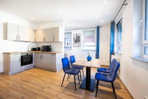 a kitchen and dining room with a table and chairs at Schmitt Bräu - Hotel und Brauereigasthof in Scheßlitz +9 photos