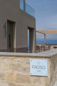 a sign on a wall in front of a house at Amnia Villas with Private Pool in Kapsalianá