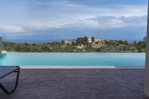 a swimming pool with a view of a city at Amnia Villas with Private Pool in Kapsalianá