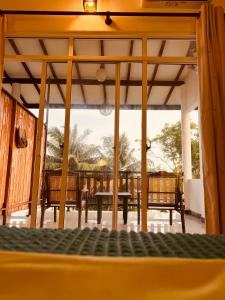 a view of a patio with chairs and a table at KVA Talalla Beach Villa in Talalla South