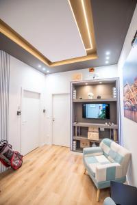 a living room with a couch and a tv at Assarotti Luxury Suite in Genoa