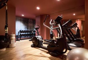 a gym with several exercise bikes in a room at Grand Powers Hotel in Paris