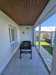 a room with a pool table on a patio at Gîte OL'HERON familiale pour 9 personnes à Dolus in Dolus-d'Oléron