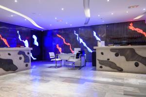a room with a table and chairs and a mural at RK Beach Hotel in Kamari