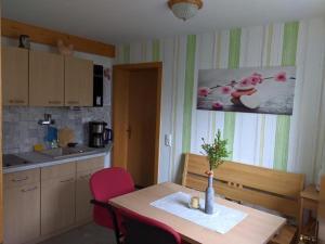 a kitchen with a table with a vase on it at Ferienwohnung Meyer in Ilmenau