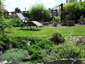 a bench sitting in the middle of a garden at Ferienwohnung Meyer in Ilmenau