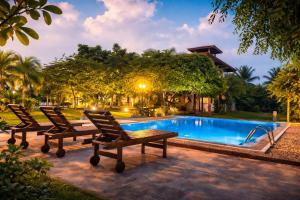 two chairs sitting next to a swimming pool at Aqua Hotel Yala in Yala