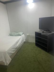 a bedroom with a bed and a flat screen tv at Duval in Calama +13 photos