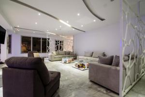 a living room with two couches and a table at RK Beach Hotel in Kamari