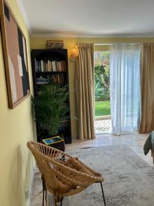 a room with a table and a chair and a book shelf at MAR VERDE - Parede-Cascais in Parede