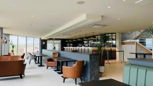 a bar in a restaurant with tables and chairs at The Cliff Hotel & Spa in Cardigan