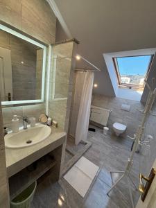 a bathroom with a sink and a shower and a toilet at Euro Accommodation in Debrecen +32 photos