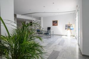 an office with a table and chairs and a plant at RK Beach Hotel in Kamari