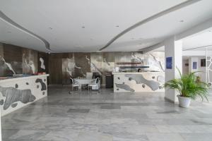 a lobby with a table and chairs in a room at RK Beach Hotel in Kamari