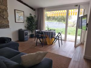 a living room with a table and a dining room at Casa Do Refugio Guest House in Covilhã