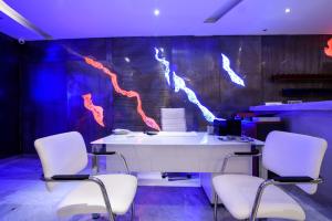 an office with a white desk with three chairs at RK Beach Hotel in Kamari