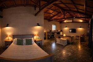 a bedroom with a large bed in a room at Vanilla Lodge Tropical Garden Suite with Outdoor Stone Bath & Bamboo Shower, inifinity pool in Cap Malheureux +41 photos