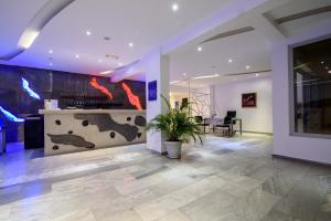 a lobby with a fireplace in a building at RK Beach Hotel in Kamari +19 photos