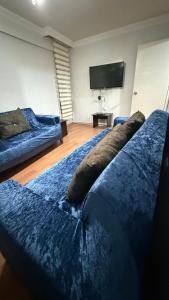a room with two beds and a flat screen tv at Fortuna House in Ankara