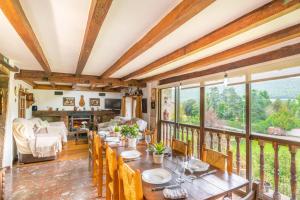 a dining room with a table and some windows at Casa Arozenia, Hogar rústico en pleno valle Ulzama in Lizaso