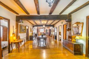 a living room with a wooden floor and a dining room at Casa Arozenia, Hogar rústico en pleno valle Ulzama in Lizaso