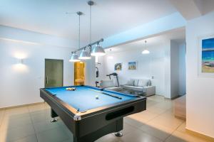 a living room with a pool table in it at Villa Ariadne in Achlia