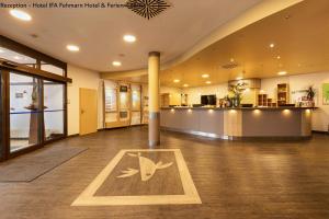 a large room with a lobby with a reception hall at IFA Yachthafen Fehmarn in Fehmarn