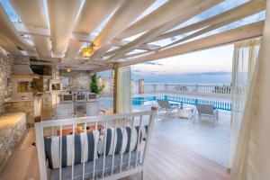 a kitchen and living room with a view of the ocean at Villa Ariadne in Achlia