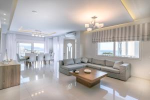 a living room with a couch and a table at Villa Ariadne in Achlia