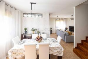 a dining room and living room with a table and chairs at Martinica By Silastur in Ferrera +93 photos