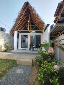 a view of a house with a thatched roof at Villa Carlos Tangalle in Tangalle