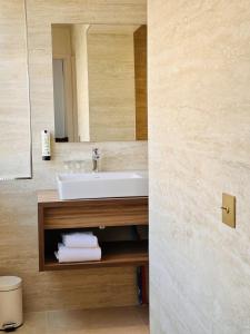 a bathroom with a sink and a mirror at Hôtel Rotonde Aix-en-Provence centre in Aix-en-Provence