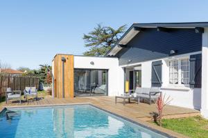 a house with a swimming pool in the backyard at Villa Blue Pool - Welkeys in Seignosse
