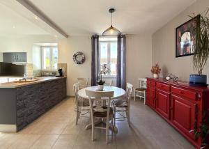 a kitchen and dining room with a table and chairs at Anetania in Saint-Palais
