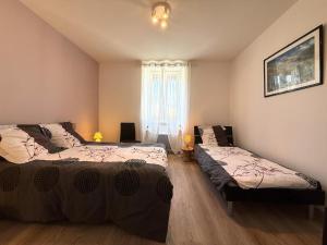 a bedroom with two beds and a window at Anetania in Saint-Palais