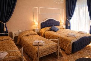 a bedroom with two beds with blue headboards at Il Borgo del Castello in Rota d'Imagna