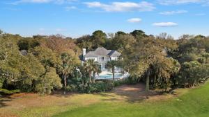 an aerial view of a house with a swimming pool and trees at GE317: 317 Glen Eagle in Kiawah Island