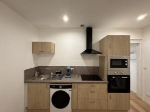 a kitchen with a sink and a stove at Le Cocon Maison Reve Excellence in Écommoy +6 photos