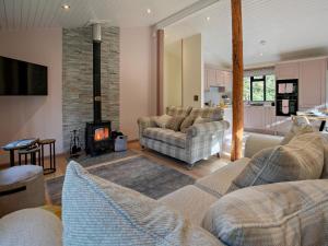 a living room with two couches and a fireplace at 2 Bed in Truro oc-93315 in Porthtowan