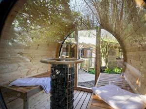 an outside view of a wooden deck with a water fountain at 2 Bed in Truro oc-93315 in Porthtowan
