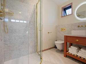 a bathroom with a glass shower and a toilet at 2 Bed in Truro oc-93315 in Porthtowan +9 photos