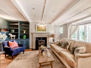 a living room with a couch and a fireplace at 4 Bed in Pulborough oc-89346 in Fittleworth