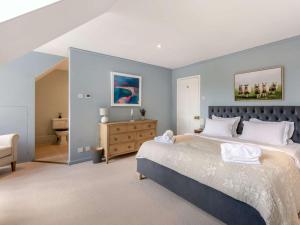 a bedroom with a large bed and a bathroom at 4 Bed in Pulborough oc-89346 in Fittleworth