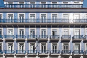 a facade of an apartment building with blue balconies at Ando Living - Abrantes 50 House in Lisbon