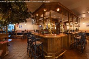a bar in a restaurant with stools at IFA Yachthafen Fehmarn in Fehmarn