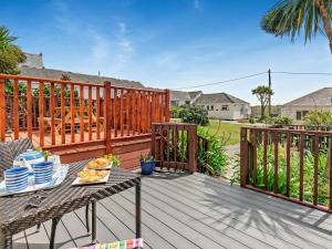 a table with a plate of food on a deck at 2 Bed in Helston oc-54556 in Mullion